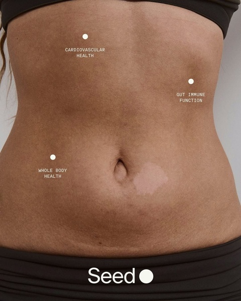 This creative uses a direct, clinical-style shot of the human abdomen with digital markers pinpointing the specific health benefits of the probiotic supplement.